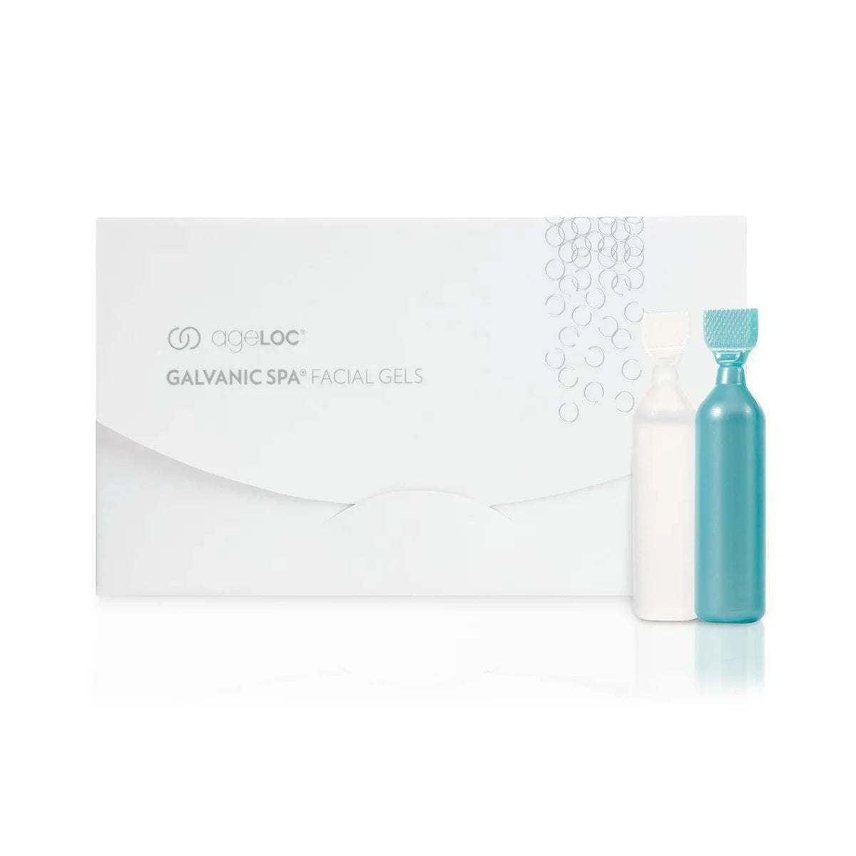 Ergänzendes Produkt zum Galvanic Spa. Produktfotografie. ageLOC Galvanic Spa Facial Gels Packung steht vor weißem Hintergrund. Davor zwei der enthaltenden Ampullen (weiß und türkis).