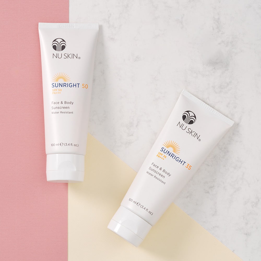 NuSkin Sunright Sonnencreme für Gesicht und Körper (SPF 35 und 50) liegen geschlossen nebeneinander auf glatter Oberfläche.